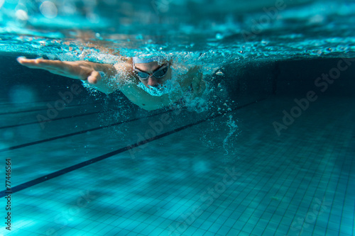Male swimmer at the swimming pool.Underwater photo.