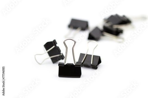 Black paper clips isolated on white background