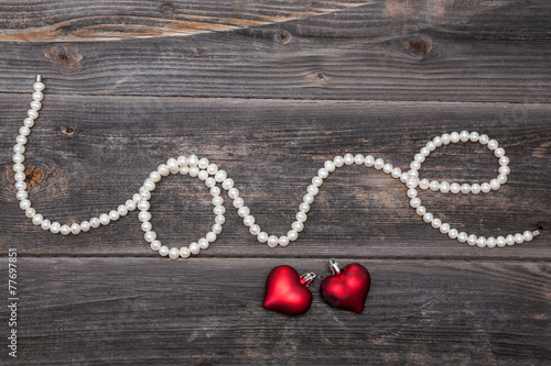 String of pearls "Love" and red hearts. Valentine's day