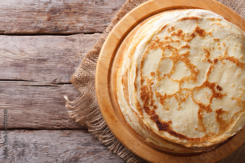 fried crepes on a chopping board horizontal top view