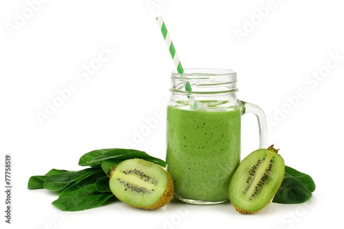 Healthy green smoothie with spinach and kiwi in a jar mug