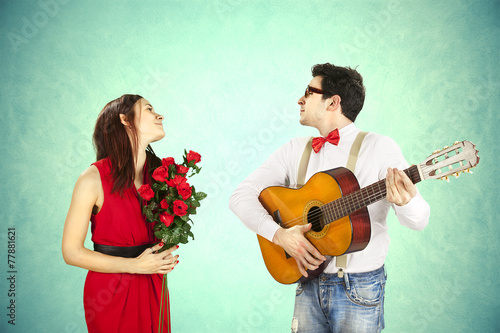 Man approaching woman playing a love song, serenade