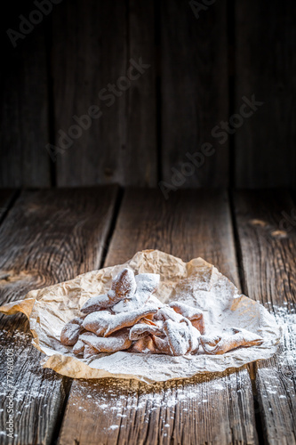 Angel wings with powdered sugar on baking paper