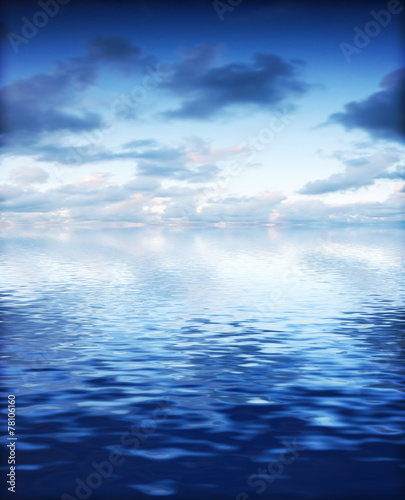 Ocean with calm waves background with dramatic sky