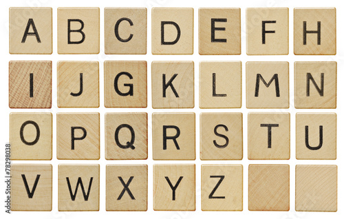 Alphabet letters on wooden scrabble pieces, isolated on white.