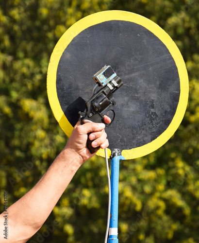 Man is shooting with a starting gun at the running race