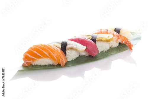 Sushi on a bamboo list over white background