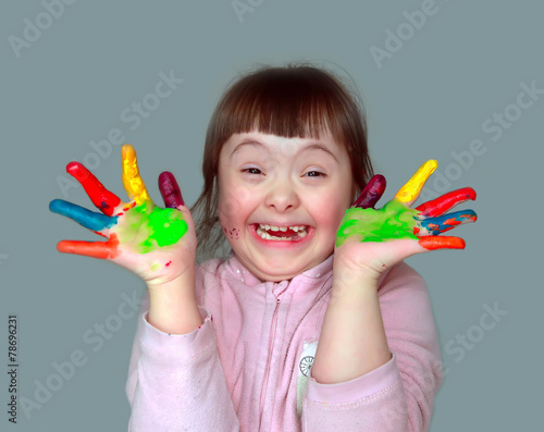 Cute little girl with painted hands.