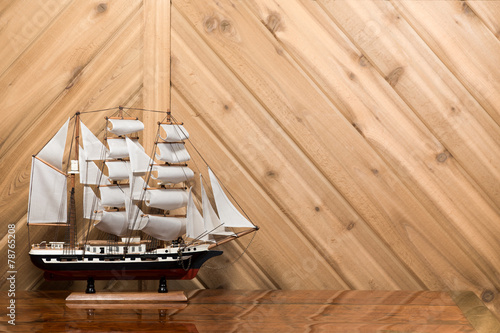 Sailboat / Model Ship against Plank Wall with Copy Space