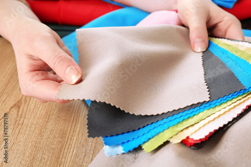 Colorful fabric samples in female hands