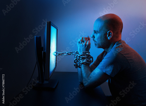 Man chained to computer