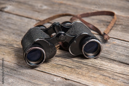 vintage binoculars on wooden background
