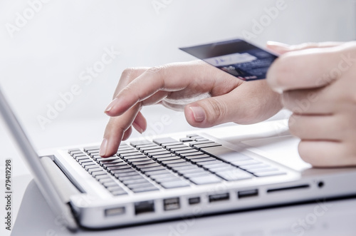 Shopping online with credit card on laptop