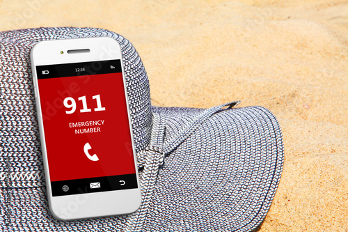 mobile phone with emergency number 911 on the beach