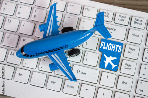 Toy airplane on keyboard online booking or purchase of plane tic