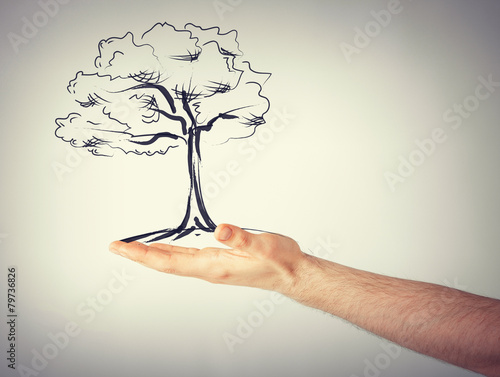 man with small tree in his hand
