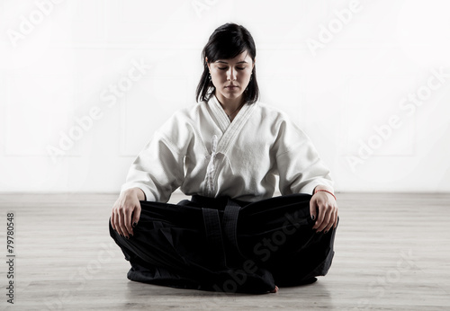 beautiful, young woman meditating in a sports hall 1