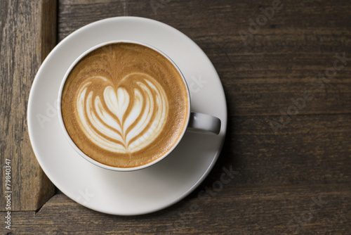 Latte art coffee on grained wood