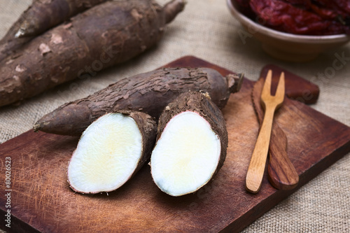 Cut manioc halves (lat. Manihot esculenta) on wooden board