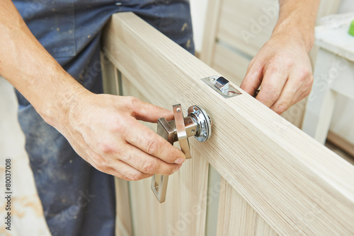 carpenter at door lock installation