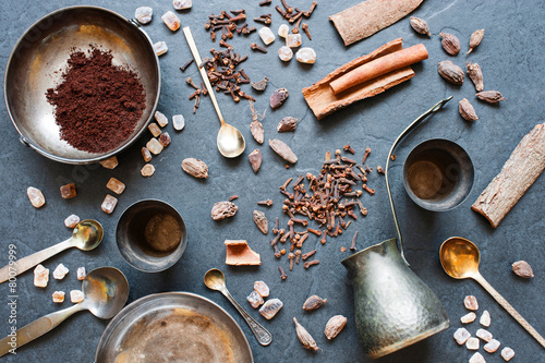 Coffee, spices and metal plates on a dark background