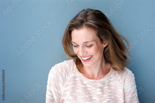 Beautiful mid adult woman laughing with sweater