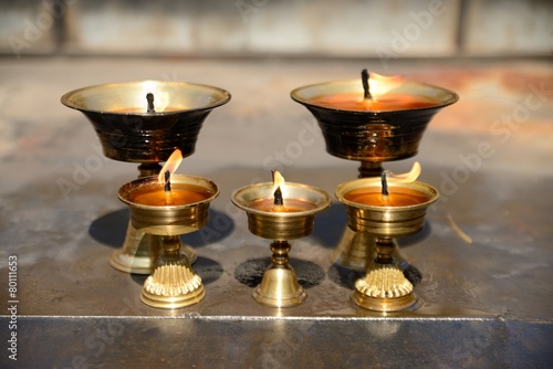 Burning Yak Butter Lamps in tibetan monastery