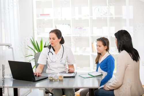 Young woman and her daughter at the doctor homeopaths