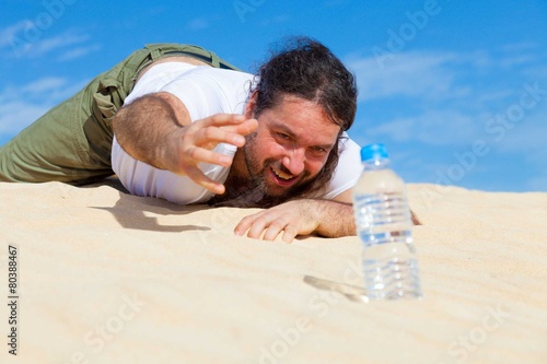 thirsty man reaches for a bottle of water in the empty