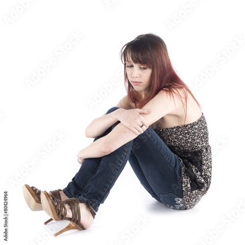 Sad Woman Sitting on the Floor Embracing her Knee