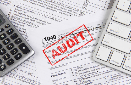 Federal tax form 1040 with keyboard and calculator