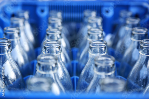 Empty bottle in blue plastic crate