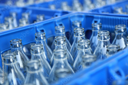 Empty bottle in blue plastic crate