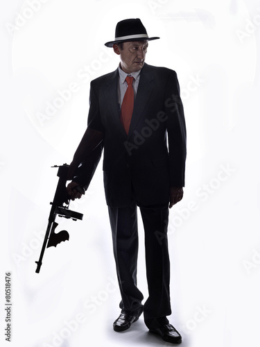 Old style gangster with tommy gun, on white background