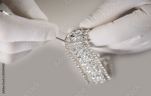 Man Hand with Gloves Putting Diamond on a Bracelet