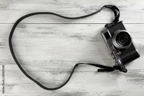 Old retro camera on wooden background