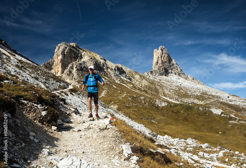 Man running downhill in Dolomites