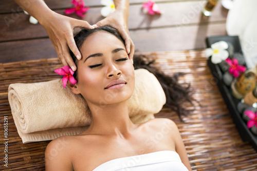 young beautiful Balinese woman receiving head massage