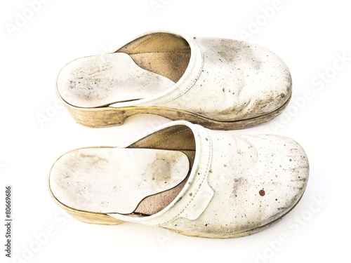 Old white woman clogs on white background seen from top
