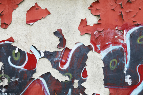 Grungy wall background texture with graffiti fragments