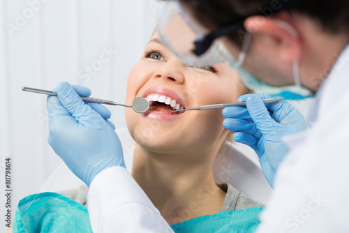 Regular dentist visit. Caries cure. Young woman visiting dentist