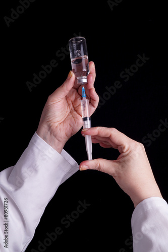 Medical vials, syringe and medical personel