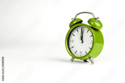 Twelve o'clock. Green classic clock on white background.