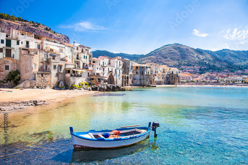 Old harbor with wooden fishing boat in Cefalu, Sicily