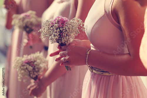 Hands of bridesmaid holding a beautiful gypsophila bouquet