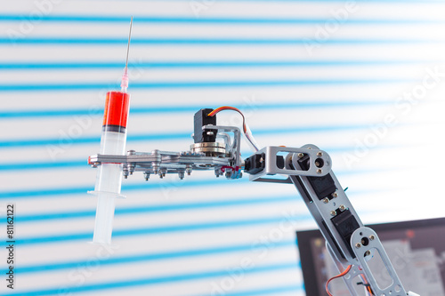 medical syringe in robot arm