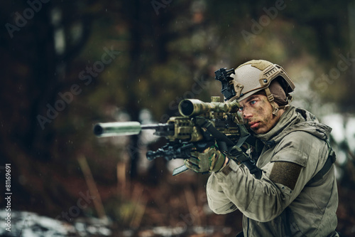 armed man in camouflage with sniper gun