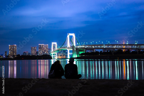 Light of Rainbow bridge at night and Tokyo tower with Couple