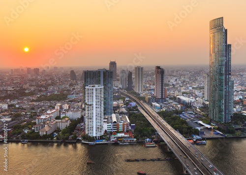 River in Bangkok city with high office building at sunset