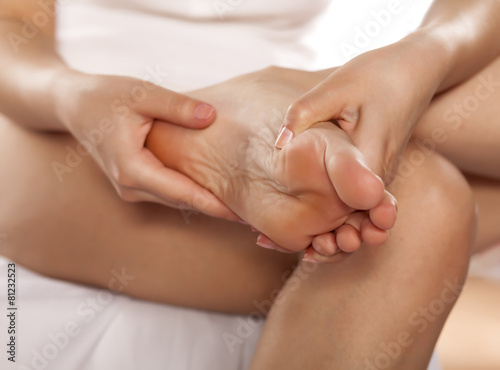 woman massaging her tired feet